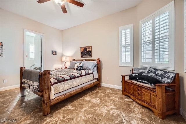 bedroom with ceiling fan and baseboards