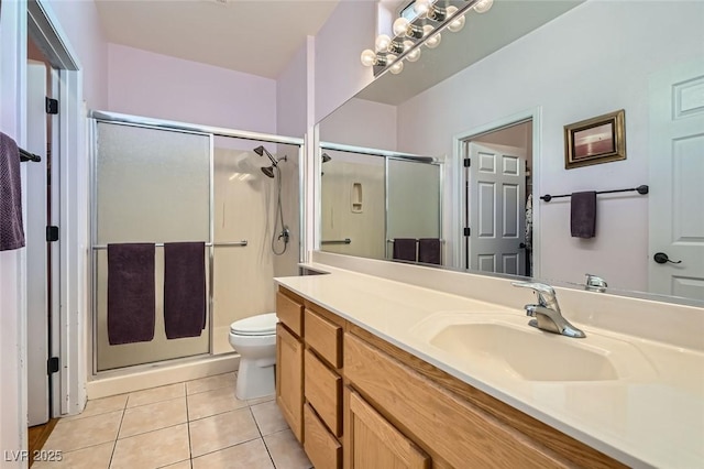 bathroom with toilet, a stall shower, tile patterned flooring, and vanity