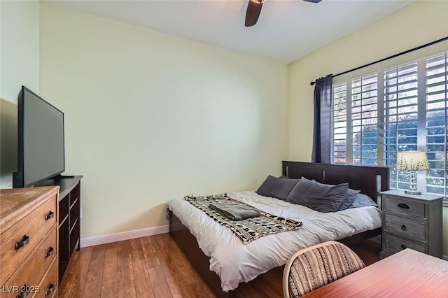 bedroom featuring ceiling fan, baseboards, and hardwood / wood-style floors