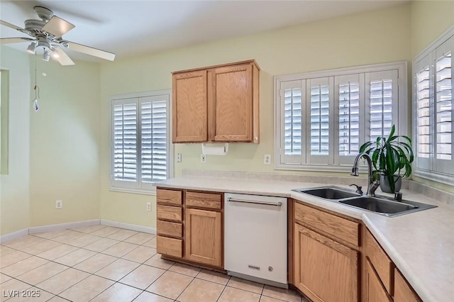 kitchen featuring dishwasher, light countertops, plenty of natural light, and a sink