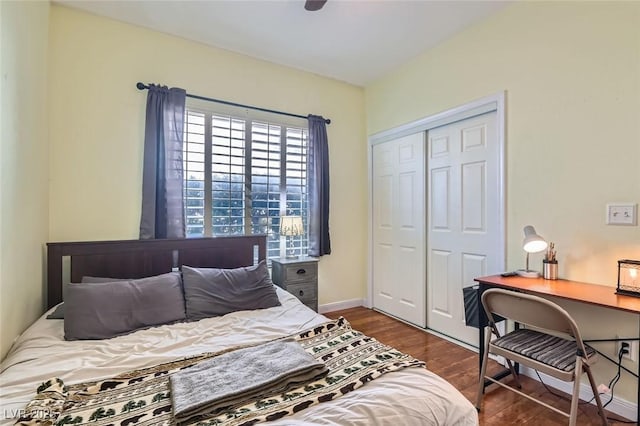 bedroom with a ceiling fan, a closet, baseboards, and wood finished floors