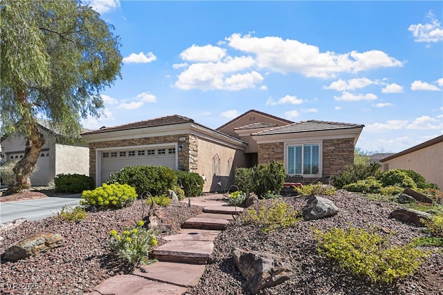 view of front of home with a garage, stone siding, and concrete driveway