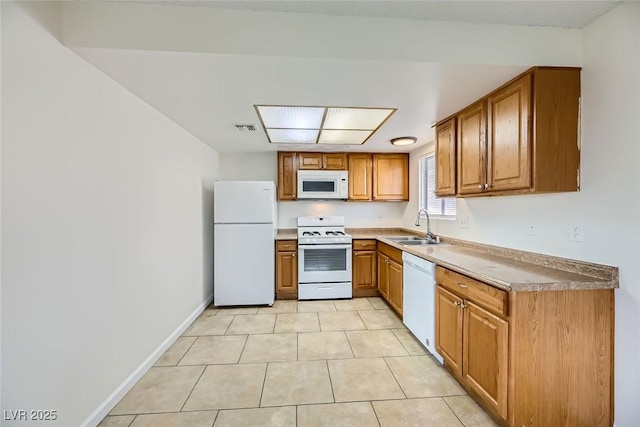 kitchen with white appliances, baseboards, visible vents, brown cabinets, and a sink