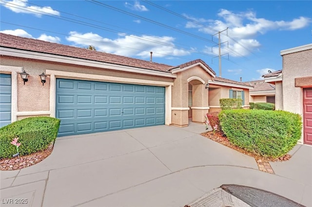 view of front of house featuring concrete driveway, an attached garage, and stucco siding