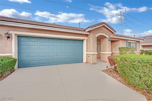 ranch-style home with concrete driveway, an attached garage, and stucco siding