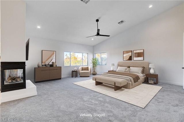 bedroom with high vaulted ceiling, recessed lighting, carpet flooring, and a multi sided fireplace