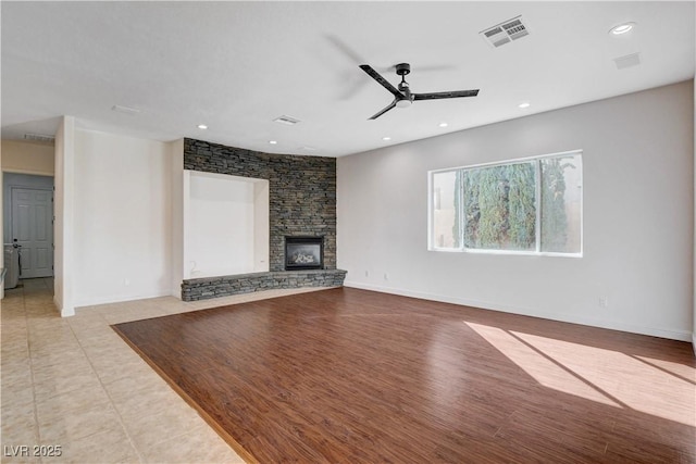 unfurnished living room featuring a fireplace, recessed lighting, visible vents, a ceiling fan, and wood finished floors