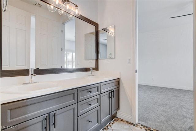 full bath with double vanity, a sink, visible vents, and baseboards