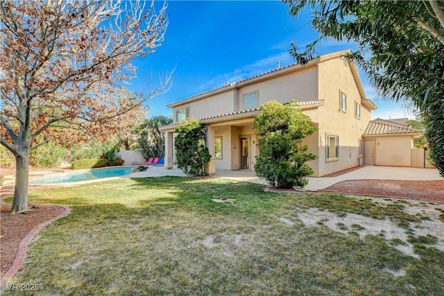 mediterranean / spanish home with a patio, fence, a fenced in pool, stucco siding, and a front yard