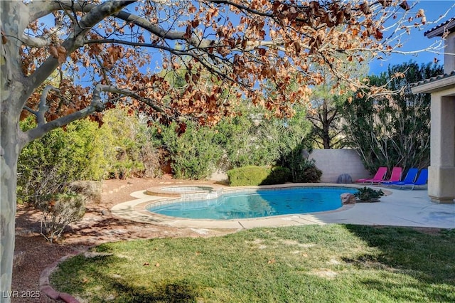 pool featuring a patio area, fence, and an in ground hot tub