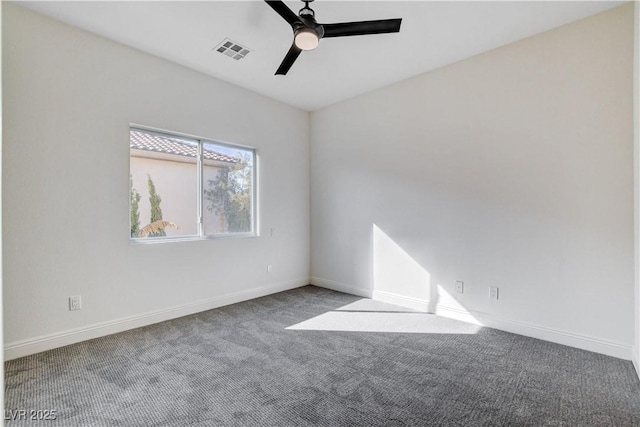 unfurnished room with carpet, visible vents, ceiling fan, and baseboards