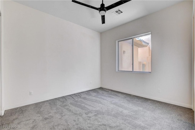 spare room featuring carpet floors, visible vents, ceiling fan, and baseboards