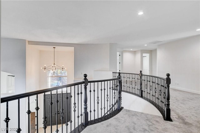 hallway featuring recessed lighting, carpet flooring, an upstairs landing, baseboards, and an inviting chandelier