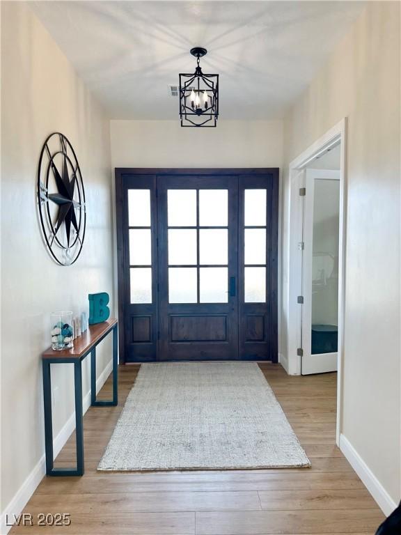 5208 Blue Desert Trl, Caliente, NV 89008 - foyer entrance with baseboards, wood finished floors, and a chandelier