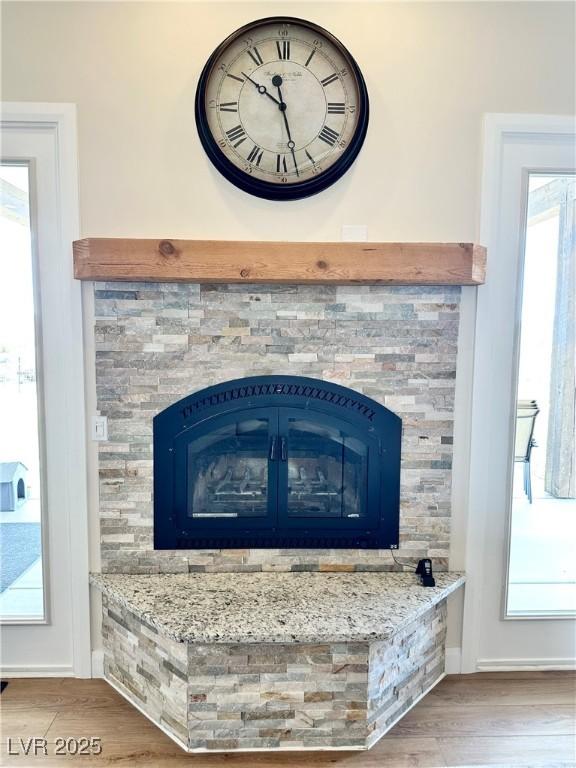 5208 Blue Desert Trl, Caliente, NV 89008 - detailed view of wood finished floors, baseboards, and a stone fireplace