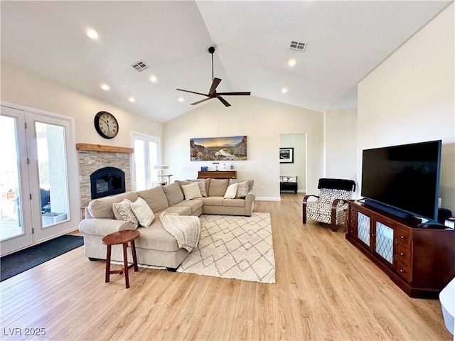 5208 Blue Desert Trl, Caliente, NV 89008 - living area with light wood-type flooring, ceiling fan, vaulted ceiling, baseboards, and a stone fireplace
