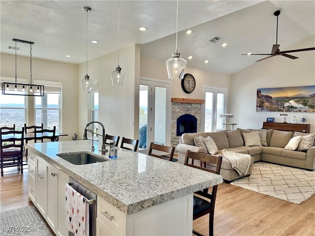 5208 Blue Desert Trl, Caliente, NV 89008 - kitchen featuring a sink, light wood finished floors, dishwashing machine, open floor plan, and lofted ceiling