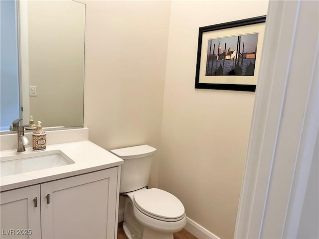 bathroom featuring toilet and vanity