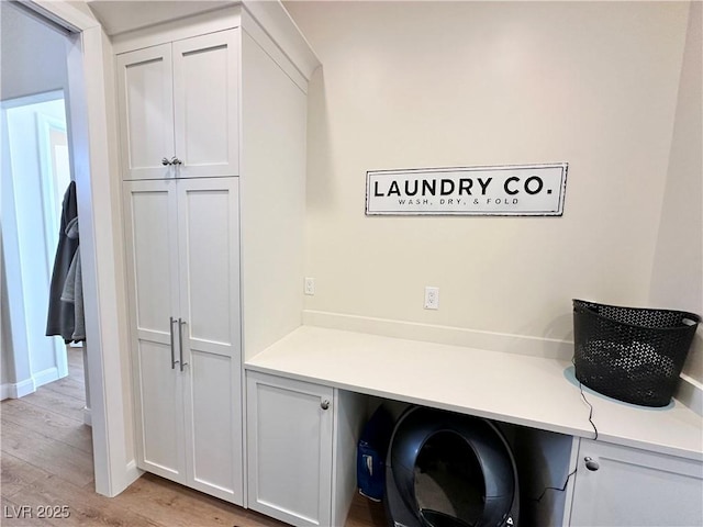 5208 Blue Desert Trl, Caliente, NV 89008 - laundry area featuring light wood finished floors, baseboards, cabinet space, and an office area