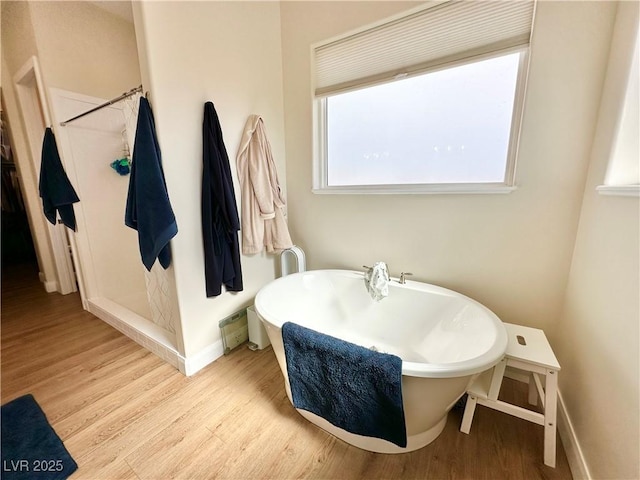5208 Blue Desert Trl, Caliente, NV 89008 - full bathroom with wood finished floors, baseboards, a stall shower, and a freestanding bath