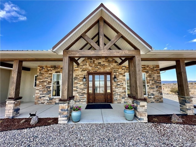 doorway to property featuring stone siding