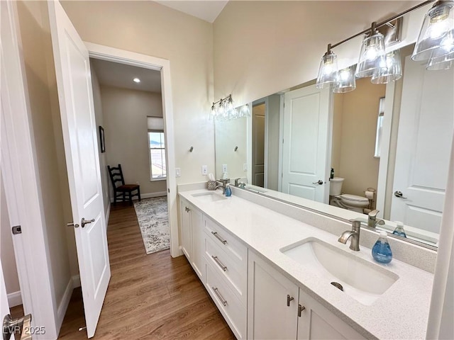 5208 Blue Desert Trl, Caliente, NV 89008 - bathroom with toilet, wood finished floors, double vanity, and baseboards