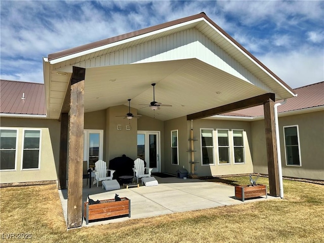 5208 Blue Desert Trl, Caliente, NV 89008 - back of property featuring ceiling fan, a patio, stucco siding, metal roof, and a lawn