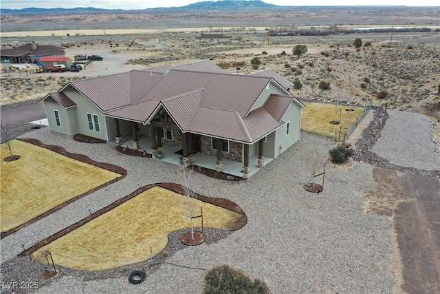 drone / aerial view featuring a mountain view and view of desert