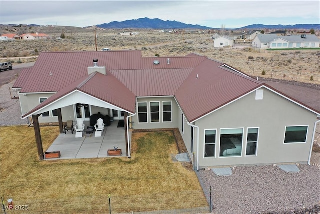 5208 Blue Desert Trl, Caliente, NV 89008 - rear view of house with a mountain view, a patio area, a yard, and metal roof