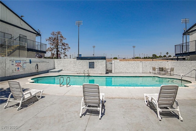 community pool featuring a patio area and fence