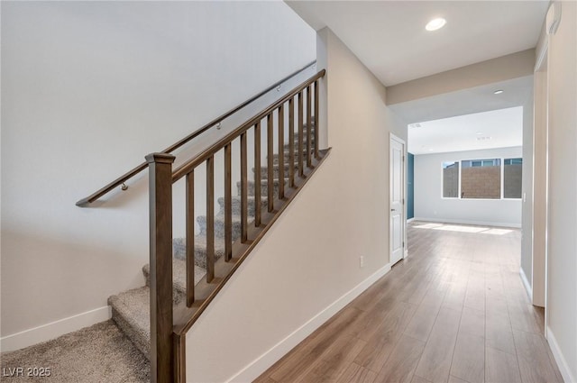 stairs with recessed lighting, baseboards, and wood finished floors