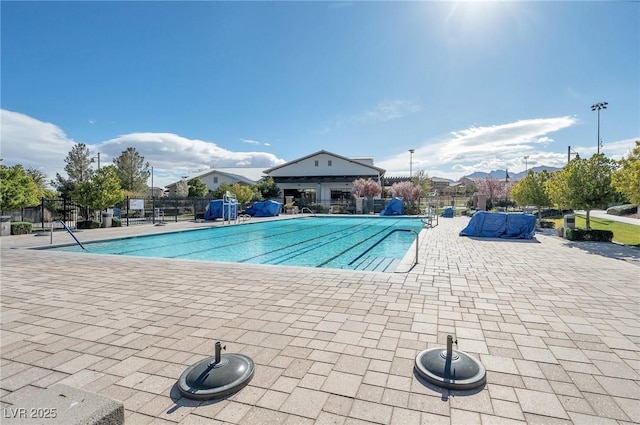 community pool featuring fence and a patio