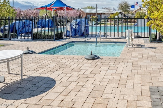 pool featuring a patio area and fence