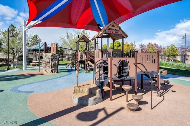 communal playground featuring fence