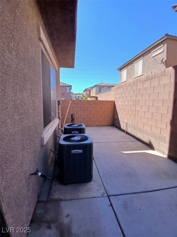 view of patio featuring a fenced backyard and central air condition unit