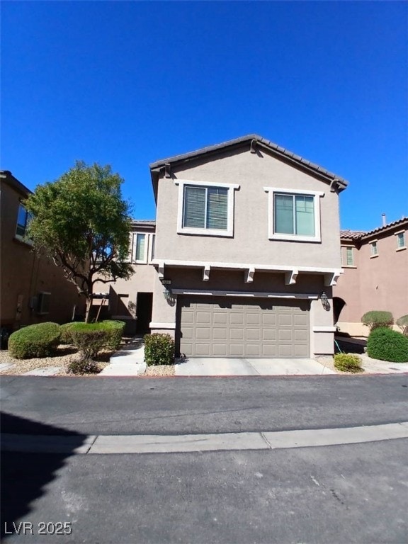 view of front of home with a garage and stucco siding