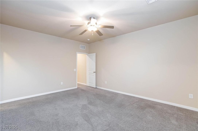 carpeted empty room featuring visible vents, ceiling fan, and baseboards