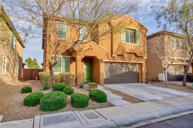 view of front of property featuring a garage, concrete driveway, fence, and stucco siding