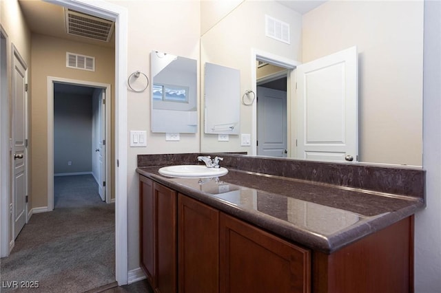 bathroom featuring vanity, visible vents, and baseboards