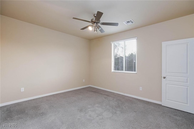 empty room featuring a ceiling fan, carpet flooring, visible vents, and baseboards