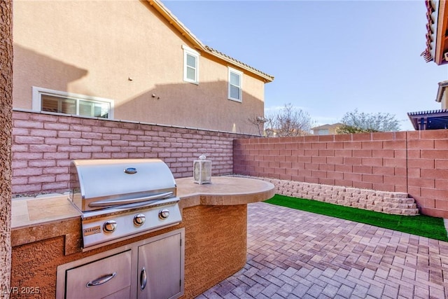 view of patio / terrace featuring fence, grilling area, and area for grilling