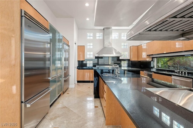 kitchen with recessed lighting, modern cabinets, stainless steel appliances, and exhaust hood