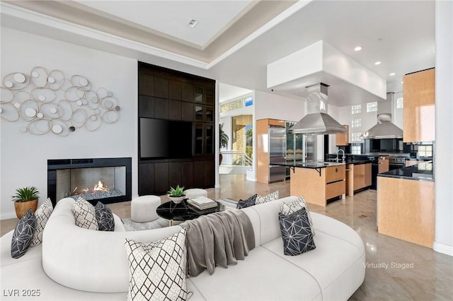 living area with recessed lighting and a glass covered fireplace