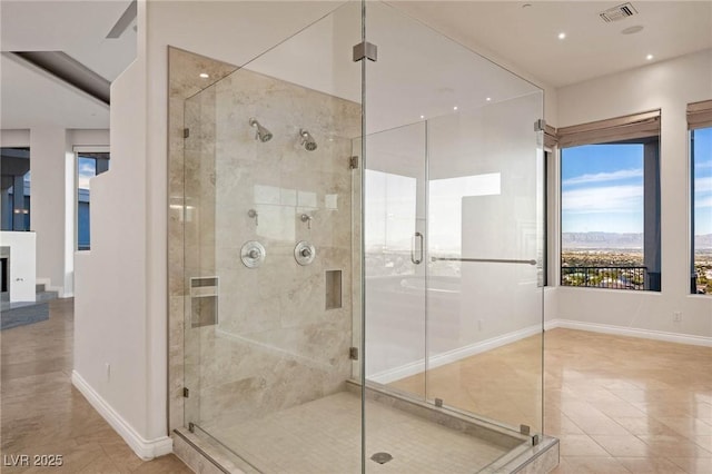 full bath with a shower stall, visible vents, and baseboards