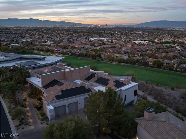 aerial view at dusk featuring a residential view and a mountain view