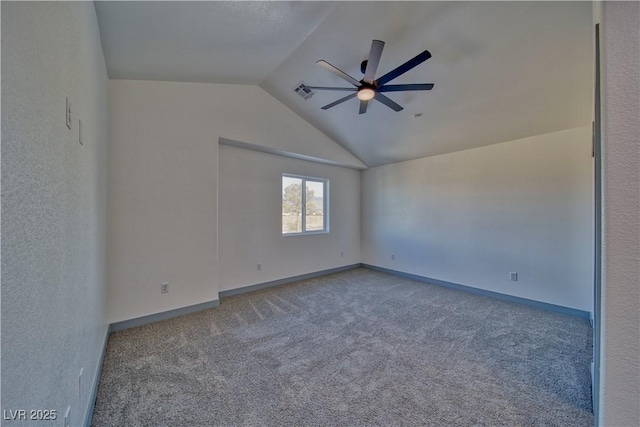 unfurnished room with lofted ceiling, carpet floors, visible vents, a ceiling fan, and baseboards