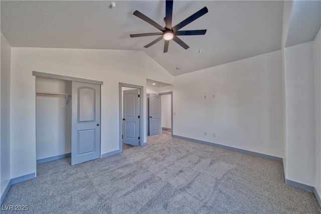 unfurnished bedroom featuring light carpet, baseboards, lofted ceiling, ceiling fan, and a closet