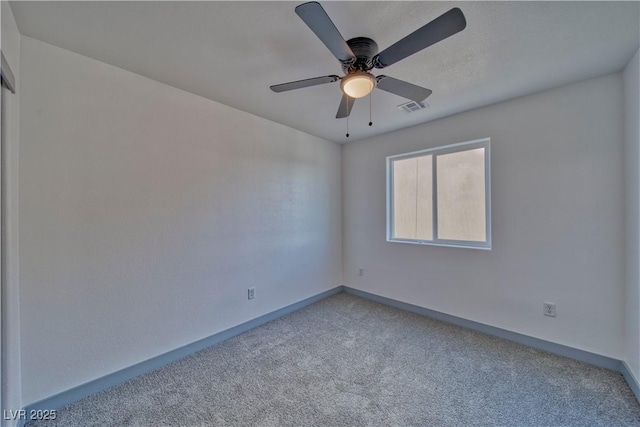 unfurnished room with ceiling fan, carpet flooring, visible vents, and baseboards
