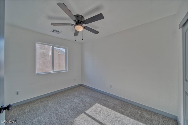 unfurnished room with a ceiling fan, carpet flooring, visible vents, and baseboards