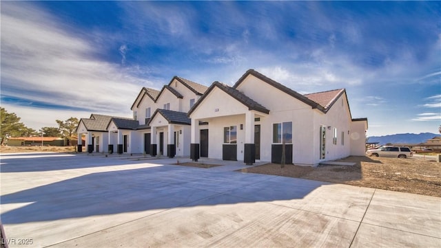 view of front of property featuring a tile roof and stucco siding